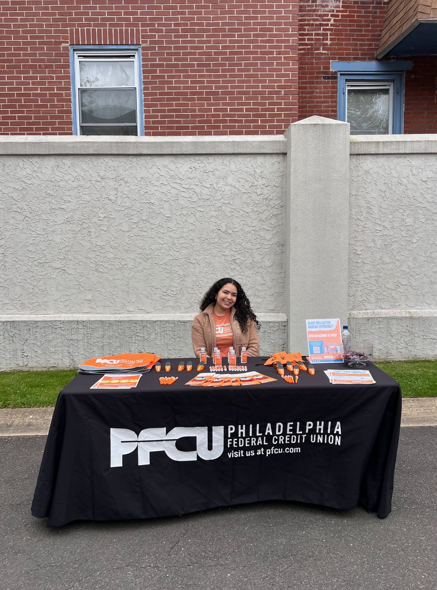 PFCU Business Development Specialist Yorkenia Gomez smiled brightly while distributing literature and free giveaways to support community engagement and financial literacy.