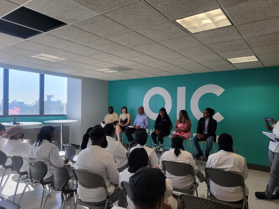 People sitting at panel discussion.
