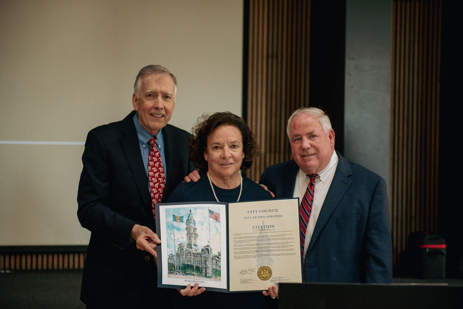 Councilmen Brian O'Neill (left) and Michael Driscoll (right) present a citation to Patricia Craven, PFCU President and CEO, in recognition of PFCU's 75th Anniversary.