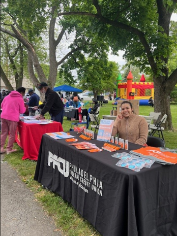 PFCU Business Development Specialist Yorkenia Gomez sitting at PFCU booth.