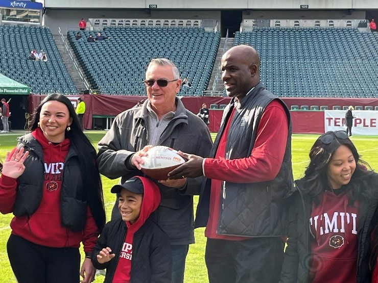 PFCU treasurer and football player with other people.